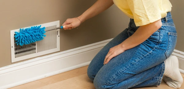 Cleaning AC vent and grille to remove dust buildup in Dubai home