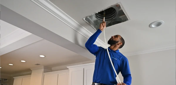Deep AC duct cleaning technician removing dust and debris from air ducts in Dubai